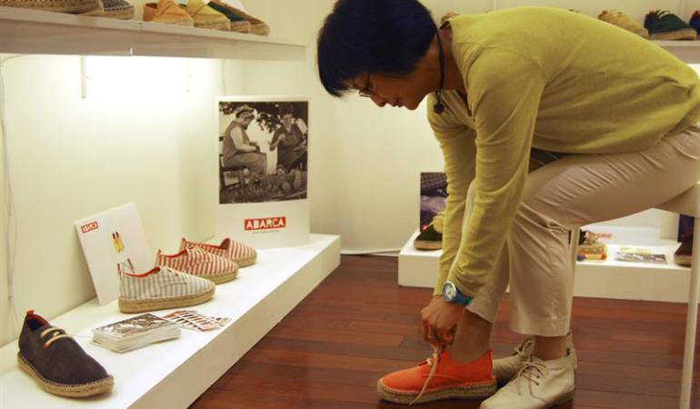 Una mujer se prueba unos zapatos con suela de alpargata de la marca española Abarca Shoes en la feria Shoes From Spain Exhibition de Tokio.