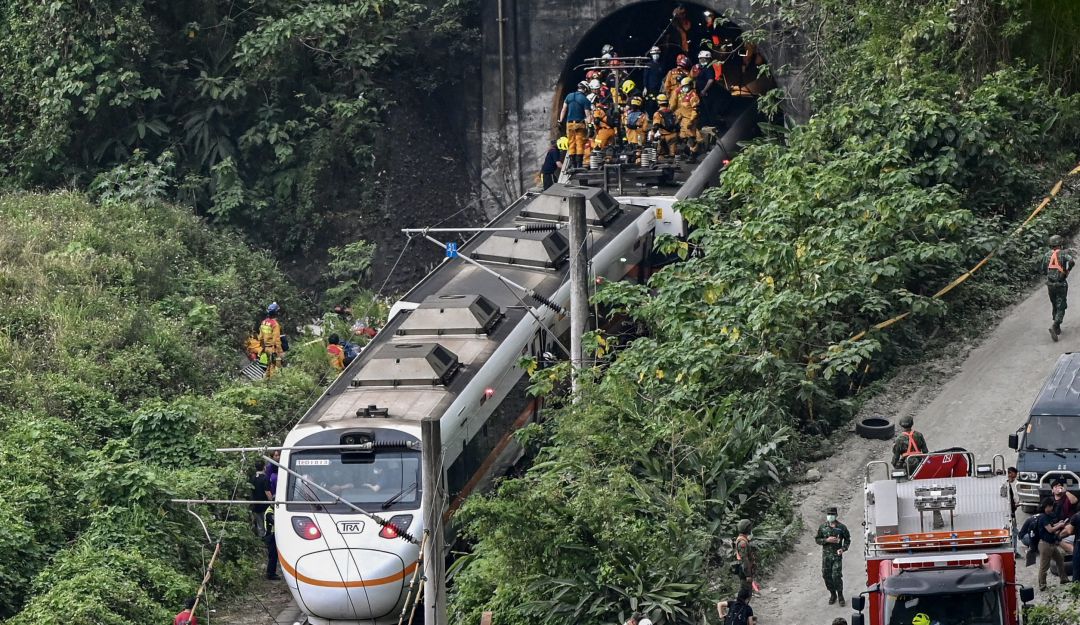 Esta foto muestra a los rescatistas en el lugar donde un tren descarriló dentro de un túnel en las montañas de Hualien, en el este de Taiwán el 2 de abril de 2021
